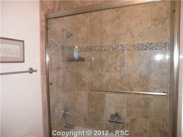 10735 Rhinestone Drive Colorado Springs, CO 80908 - Photo 11 of 16 We ran out of space for all these pics! ALL full baths have this custom floor to ceiling tile with sliding doors. Come see the house and see for yourself.