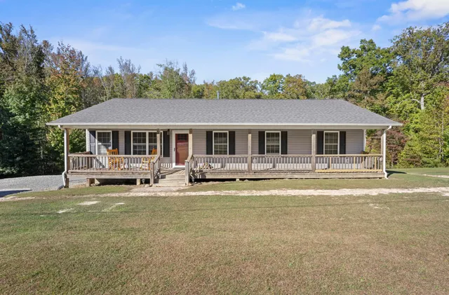 a front view of a house with a yard table and chairs
