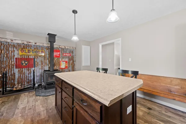 a kitchen with a table chairs and a chandelier