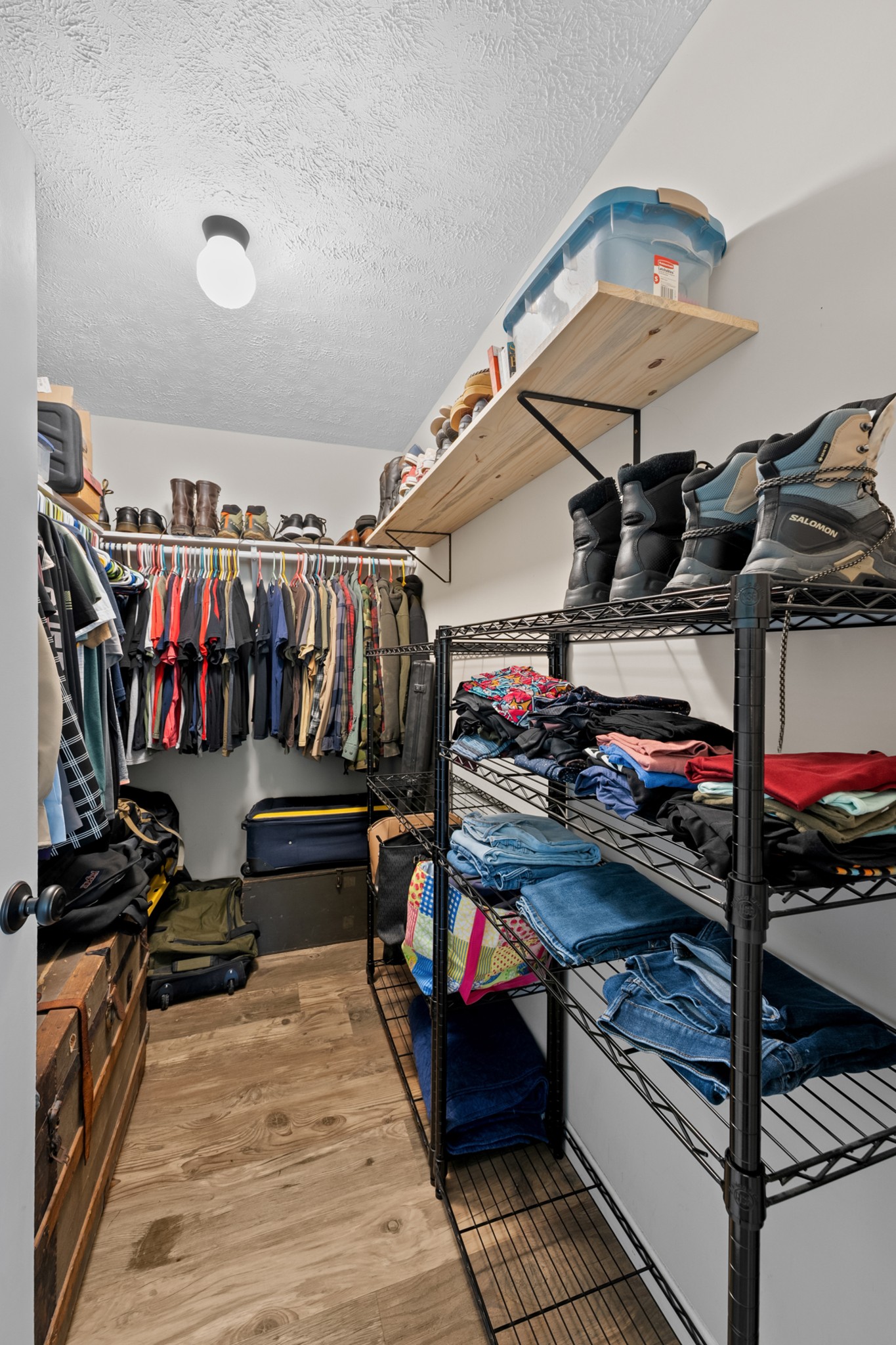 936 Adams Road Tracy City, TN 37387 - Photo 18 of 28 a view of walk in closet with clothes and shoes