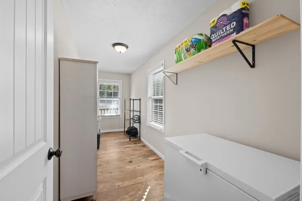 a view of an entryway with wooden floor and a ceiling fan