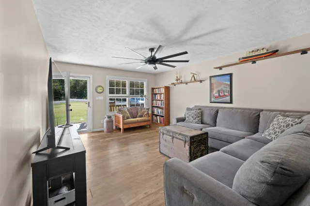 a kitchen that has a table chairs in it and wooden floors