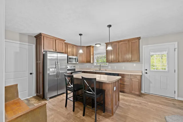 a kitchen with a sink cabinets and window