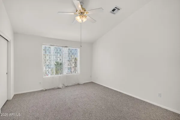a kitchen with granite countertop a sink dishwasher stove and microwave with wooden cabinets