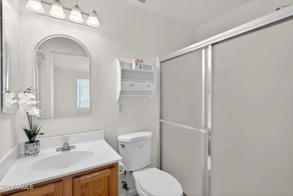 a view of an empty room with a window and a fan
