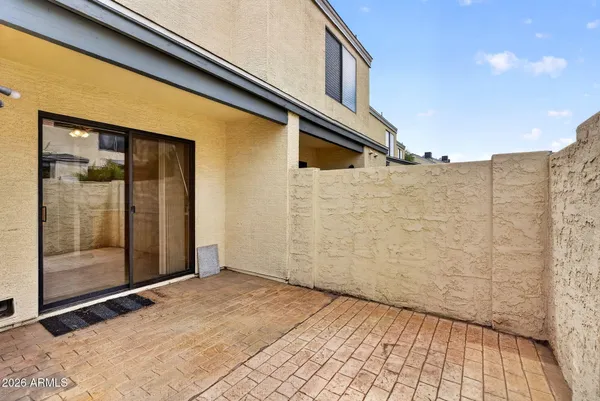 a bathroom with a sink a toilet a mirror and shower curtain
