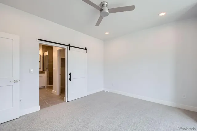 an empty room with closet and a hallway