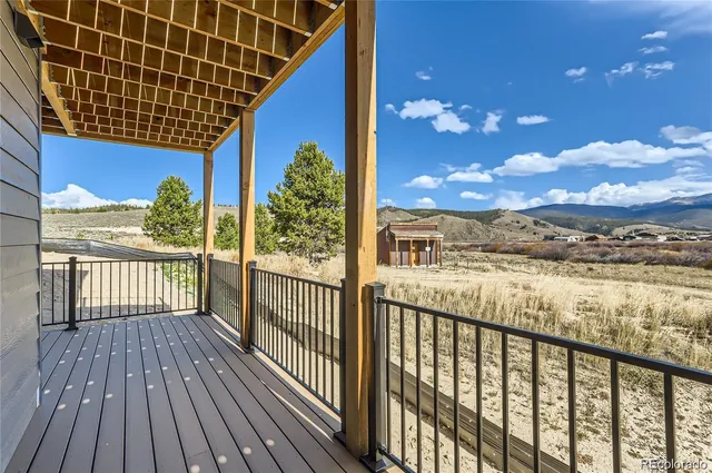 a view of a house with wooden deck