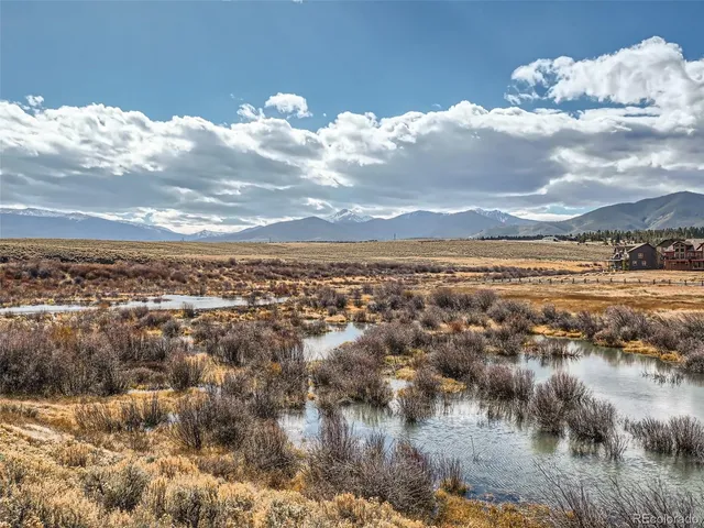 a view of a lake with outdoor seating