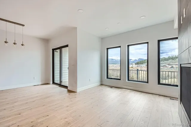 a view of an empty room with glass door and balcony