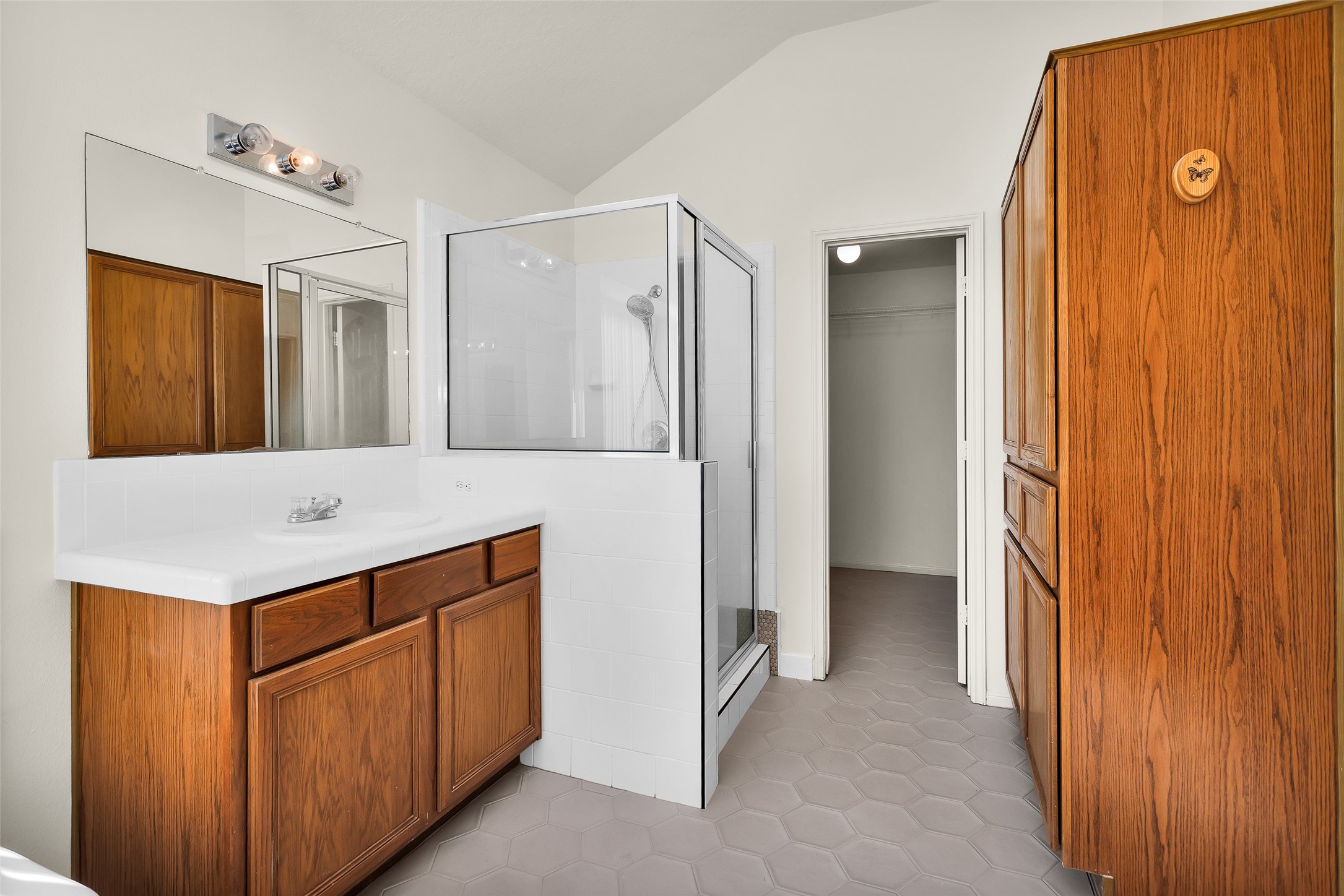 5201 Penny Road Cleveland, TX 77328 - Photo 22 of 27 a bathroom with a sink and a mirror