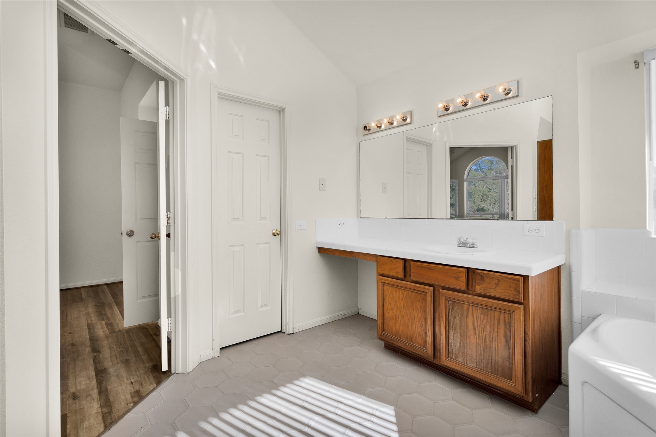 5201 Penny Road Cleveland, TX 77328 - Photo 23 of 27 a bathroom with a sink a mirror and a toilet