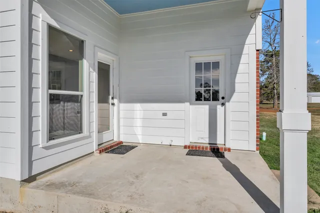 a front view of a house with a garden and yard