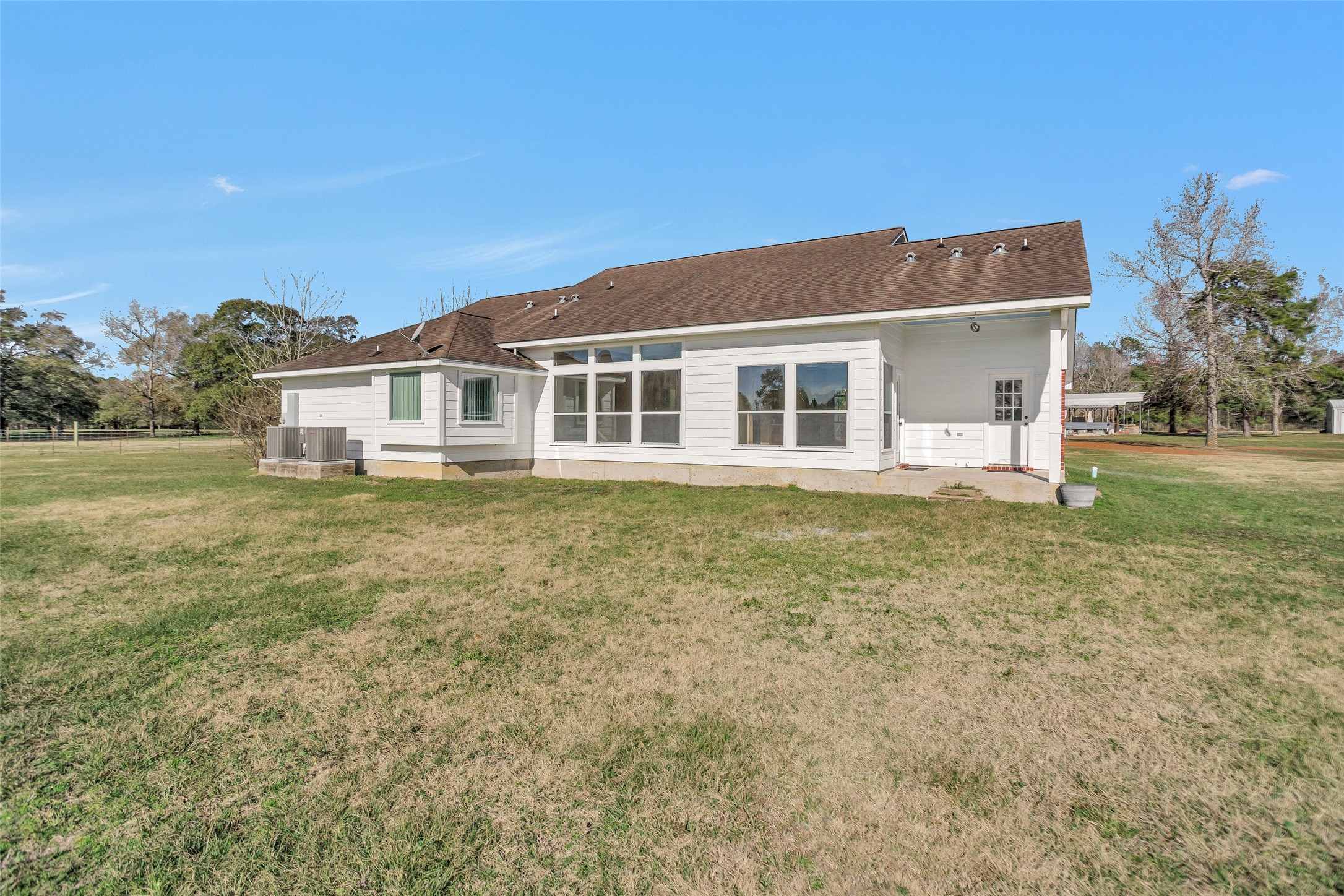5201 Penny Road Cleveland, TX 77328 - Photo 26 of 27 a front view of a house with a garden and yard