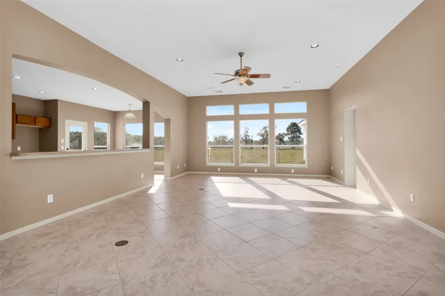 a view of a livingroom with wooden floor and a ceiling fan