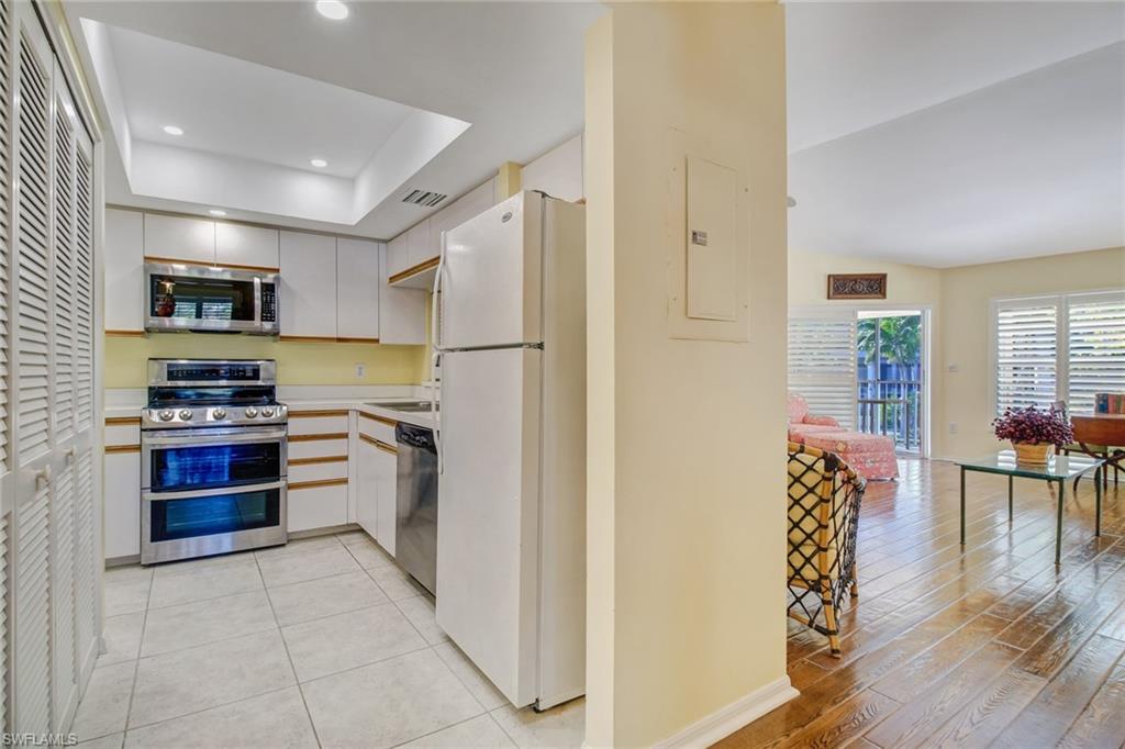 5635 Turtle Bay Drive, Unit I10 Naples, FL 34108 - Photo 12 of 25 a kitchen with stainless steel appliances a refrigerator and a stove top oven
