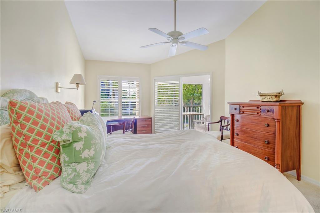 5635 Turtle Bay Drive, Unit I10 Naples, FL 34108 - Photo 15 of 25 a bedroom with a bed and dresser with mirror