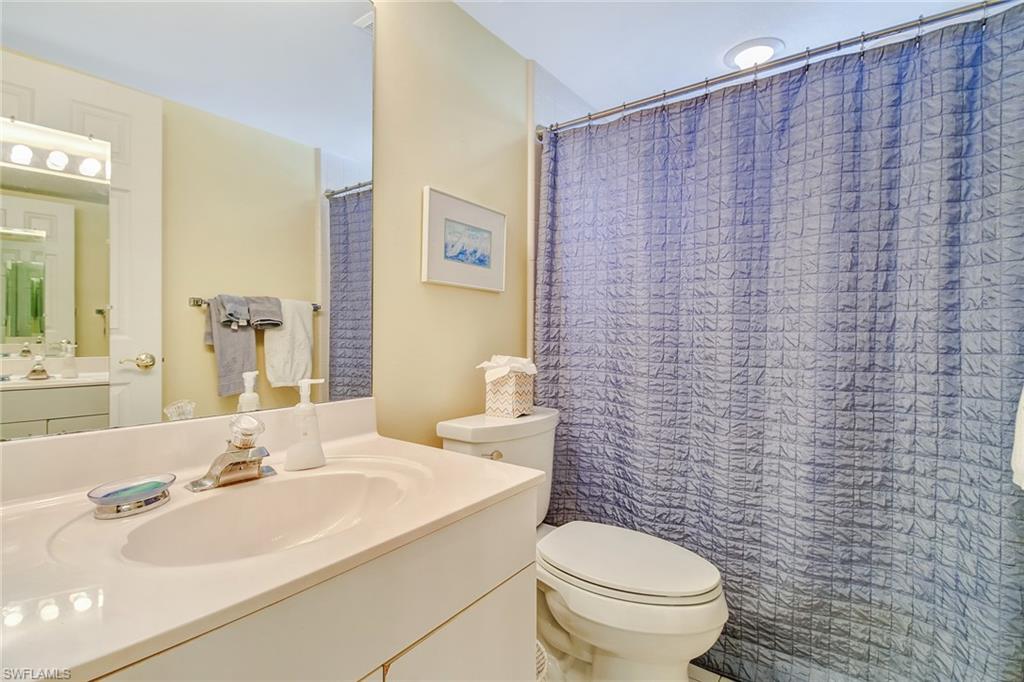 5635 Turtle Bay Drive, Unit I10 Naples, FL 34108 - Photo 20 of 25 a bathroom with a sink a toilet and a mirror