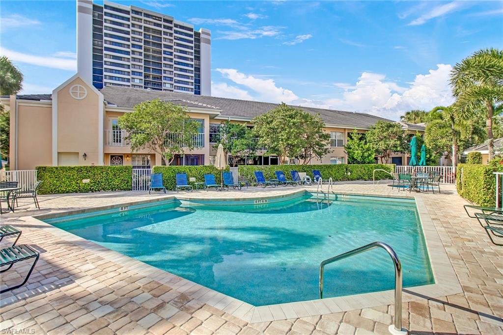 5635 Turtle Bay Drive, Unit I10 Naples, FL 34108 - Photo 22 of 25 a view of a house with a yard