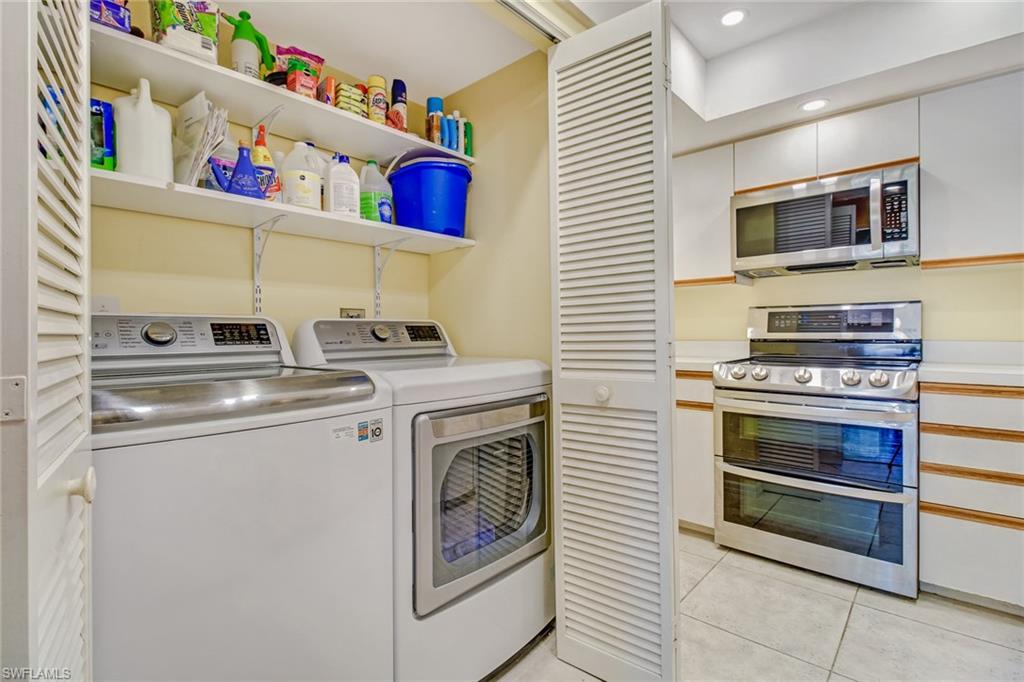 5635 Turtle Bay Drive, Unit I10 Naples, FL 34108 - Photo 25 of 25 a kitchen with stainless steel appliances granite countertop a stove and a microwave