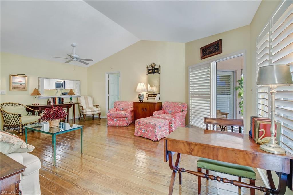 5635 Turtle Bay Drive, Unit I10 Naples, FL 34108 - Photo 4 of 25 a living room with furniture and wooden floor