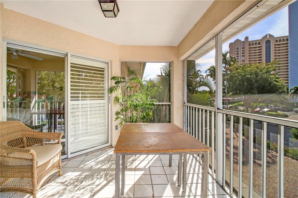 5635 Turtle Bay Drive, Unit I10 Naples, FL 34108 - Photo 8 of 25 a view of a porch with a table and chairs