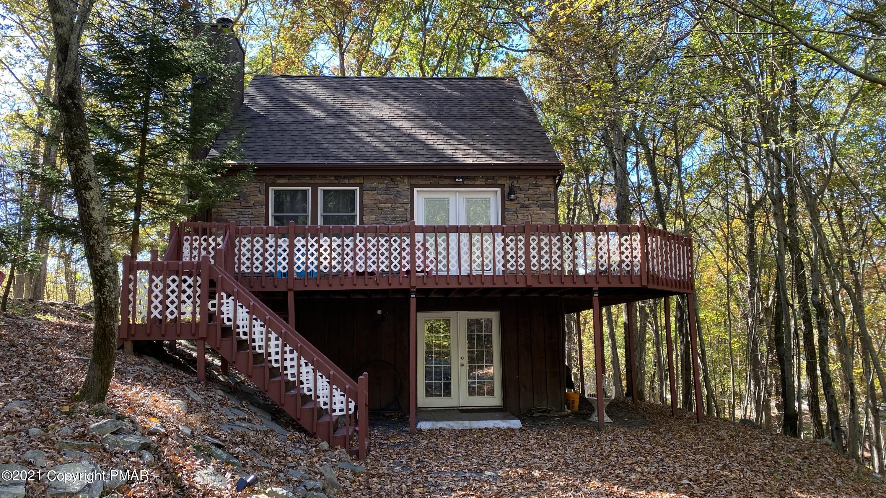 6148 Decker Road Bushkill, PA 18324 - Photo 1 of 36 a view of a house with a deck and furniture