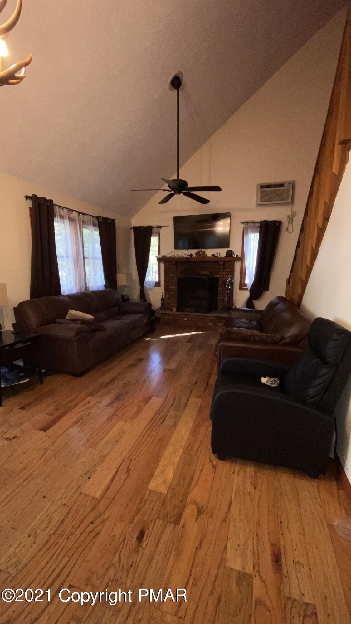 6148 Decker Road Bushkill, PA 18324 - Photo 13 of 36 a living room with furniture and a fireplace