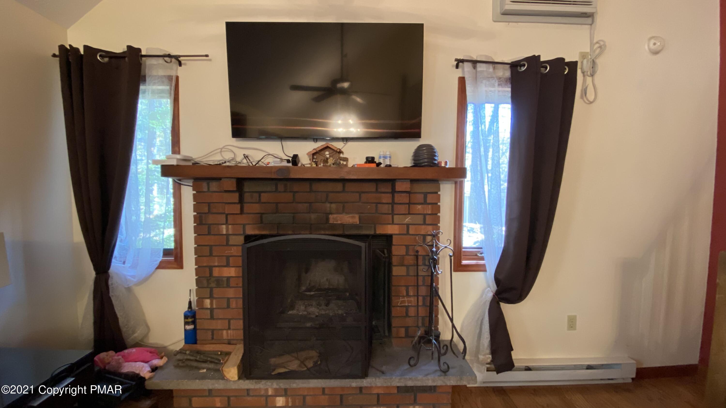 6148 Decker Road Bushkill, PA 18324 - Photo 17 of 36 a living room with furniture and a fireplace