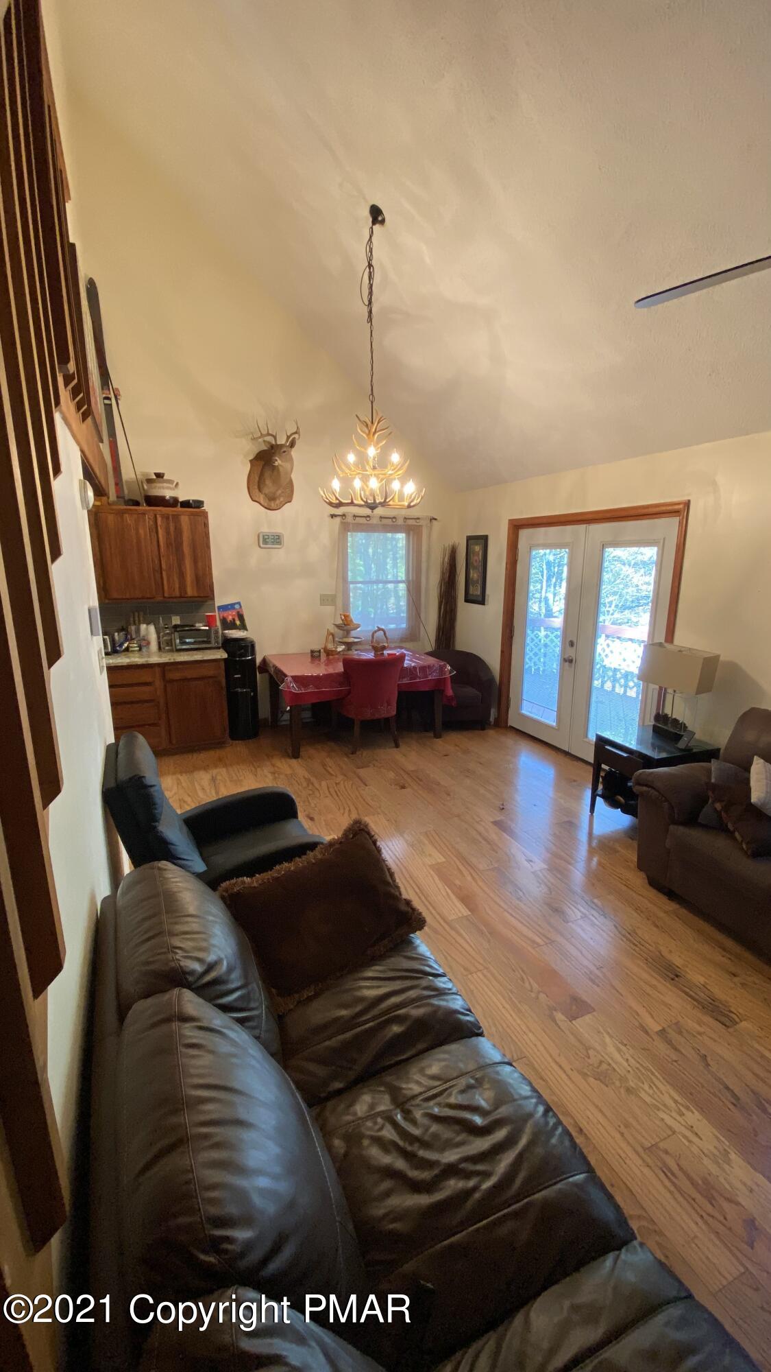 6148 Decker Road Bushkill, PA 18324 - Photo 18 of 36 a living room with furniture and a chandelier