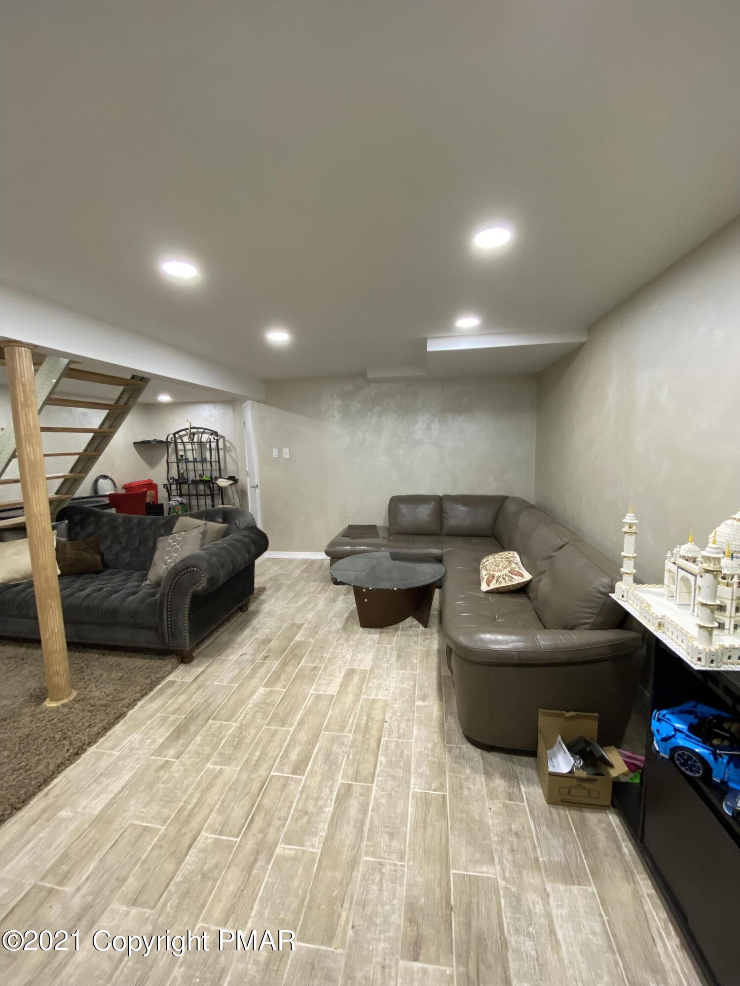 6148 Decker Road Bushkill, PA 18324 - Photo 31 of 36 a living room with furniture and a wooden floor