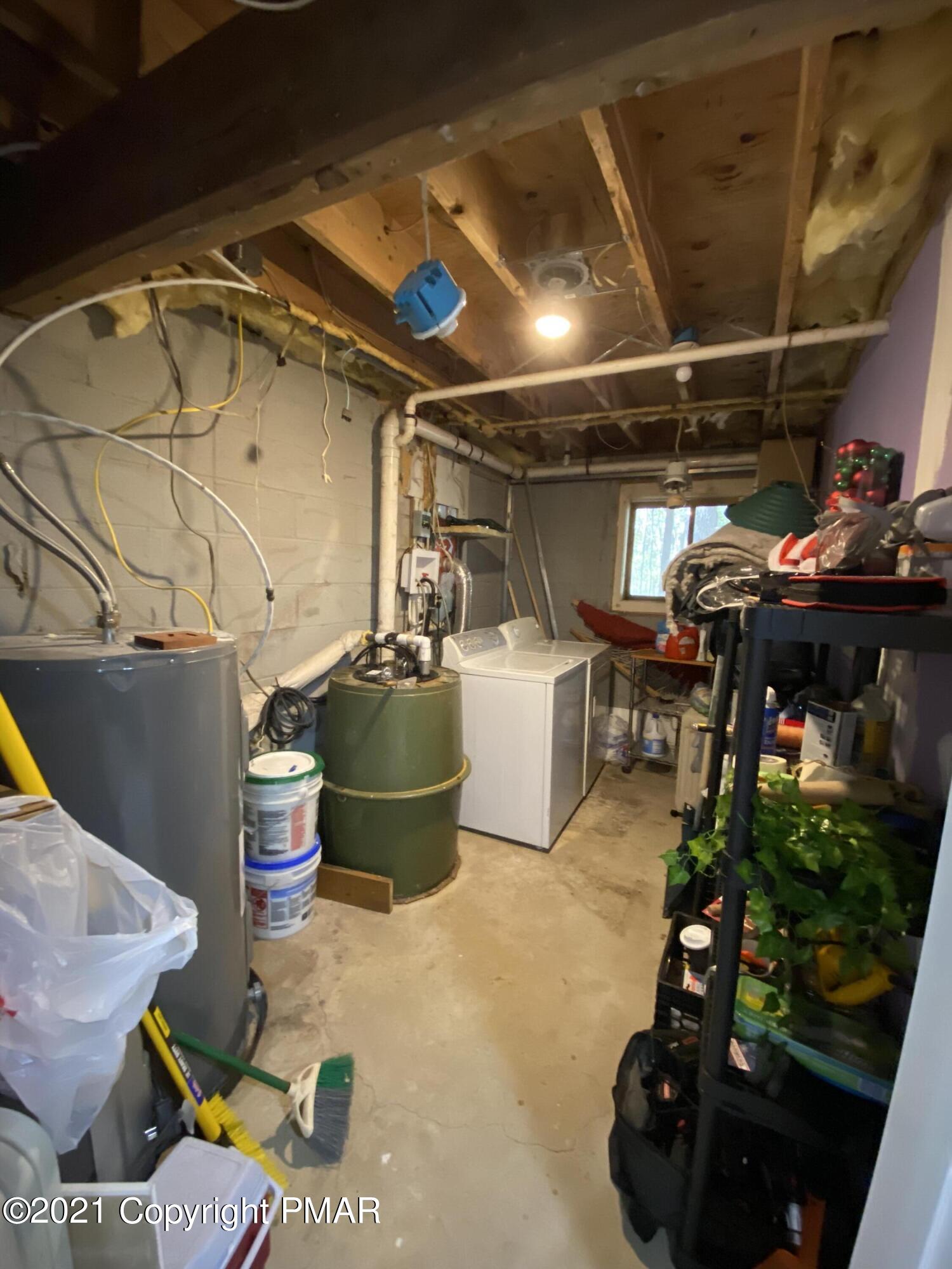 6148 Decker Road Bushkill, PA 18324 - Photo 32 of 36 a room with water heater and wooden racks