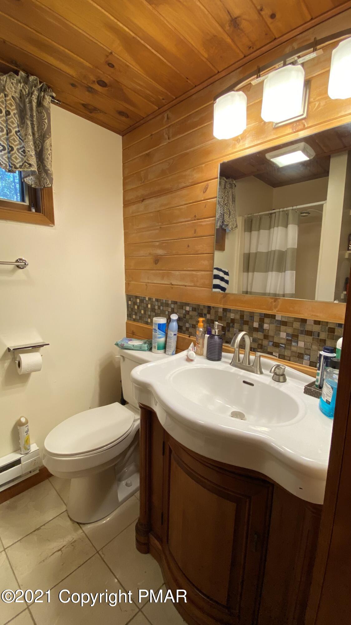 6148 Decker Road Bushkill, PA 18324 - Photo 6 of 36 a bathroom with a sink toilet and mirror