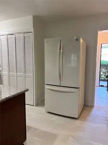 a white refrigerator freezer sitting in a kitchen