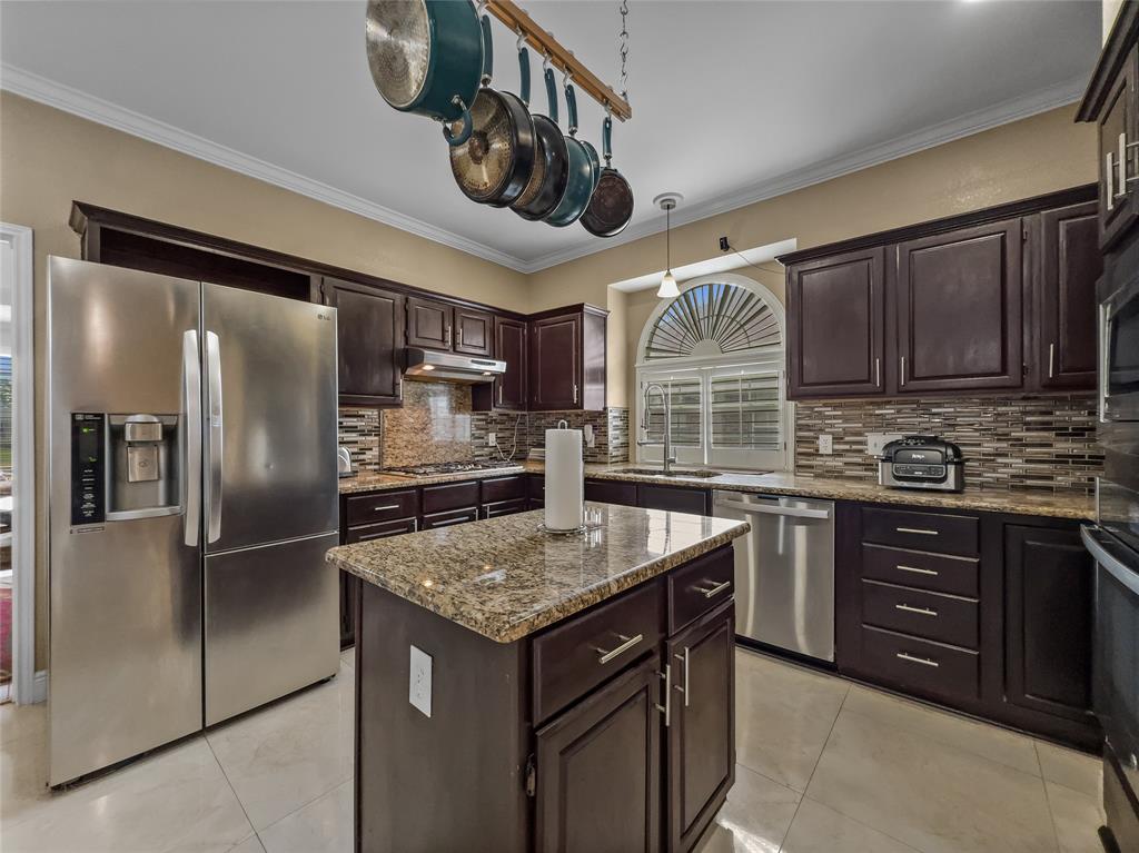 2317 Wellesly Road Rowlett, TX 75089 - Photo 5 of 39 a kitchen with stainless steel appliances granite countertop a sink stove and refrigerator