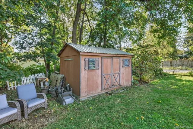 a view of a chair and table in backyard