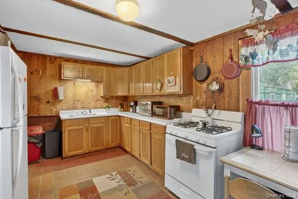 a kitchen with a stove a sink and a refrigerator