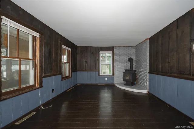 a view of a livingroom with wooden floor and windows