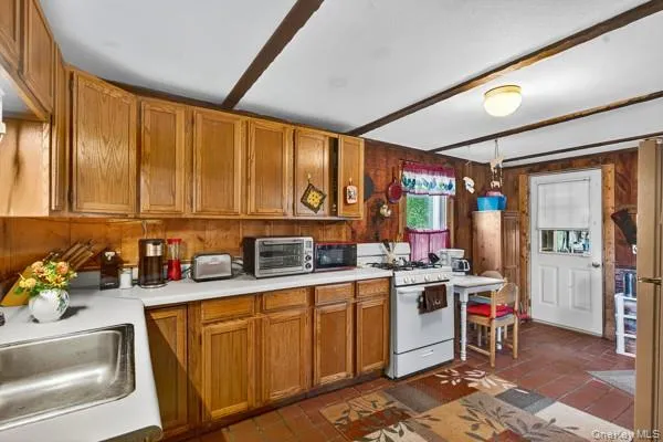 a kitchen with stainless steel appliances granite countertop a sink stove and cabinets