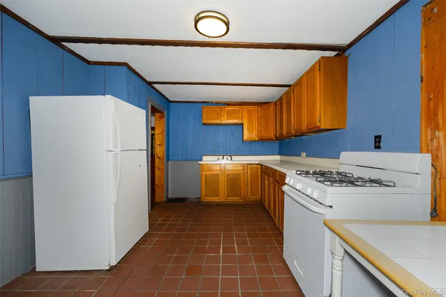 a kitchen with a stove a refrigerator and a sink
