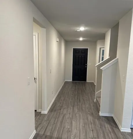 a view of hallway with wooden floor