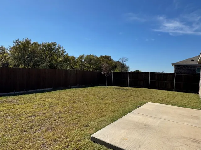 a room with a wooden floor and white wall
