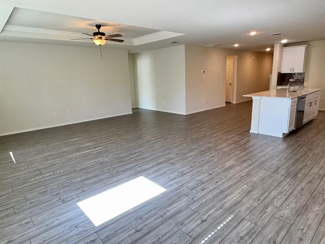 a view of a kitchen with wooden floor and a sink