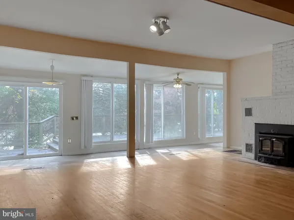 a living room with a fireplace and a wooden floor
