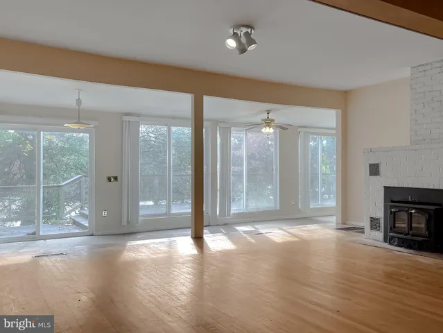 a living room with a fireplace and a wooden floor