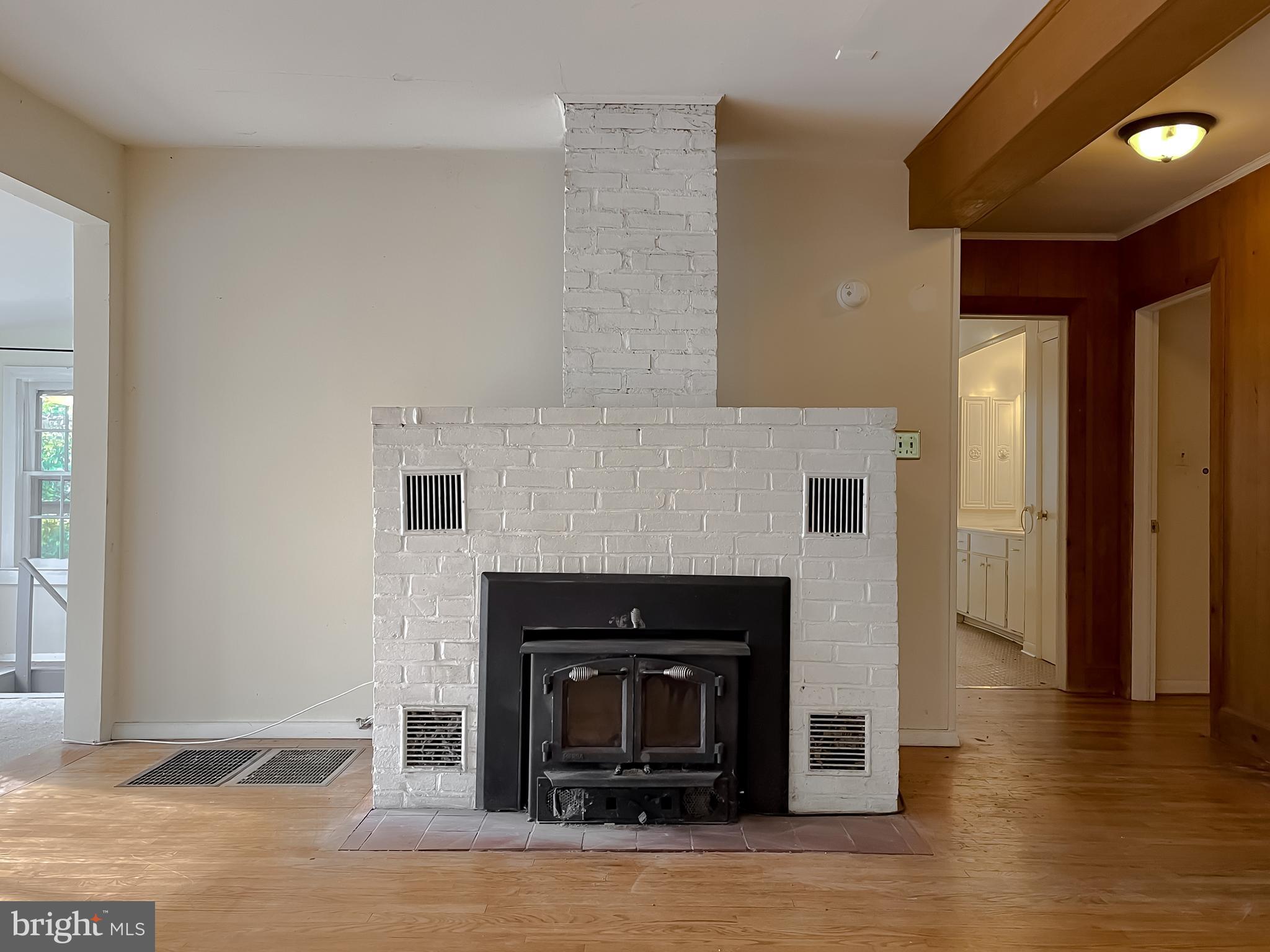 43979 Drum Cliff Road Hollywood, MD 20636 - Photo 12 of 57 a living room with a fireplace and a wooden floor