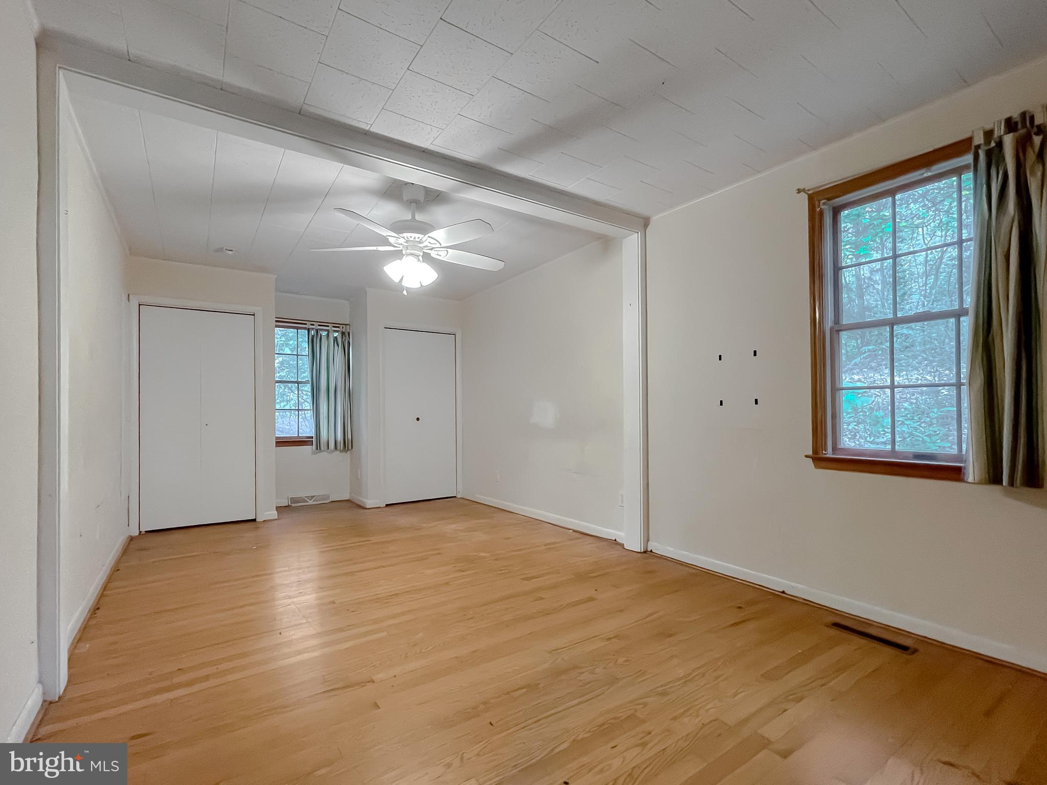 43979 Drum Cliff Road Hollywood, MD 20636 - Photo 18 of 57 a view of an empty room with window and wooden floor