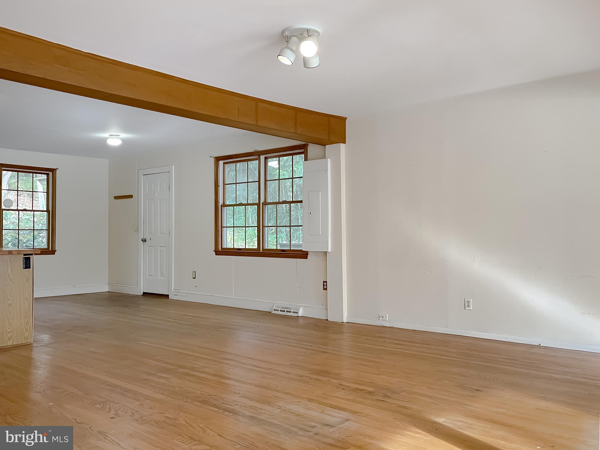 43979 Drum Cliff Road Hollywood, MD 20636 - Photo 3 of 57 an empty room with wooden floor and windows