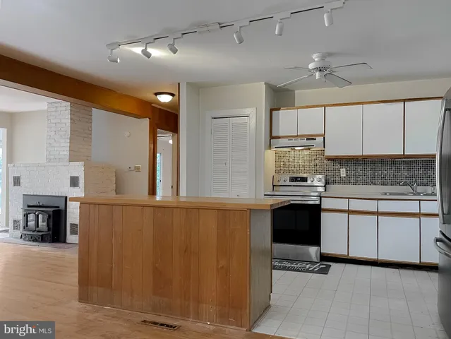 a kitchen with a sink cabinets and window