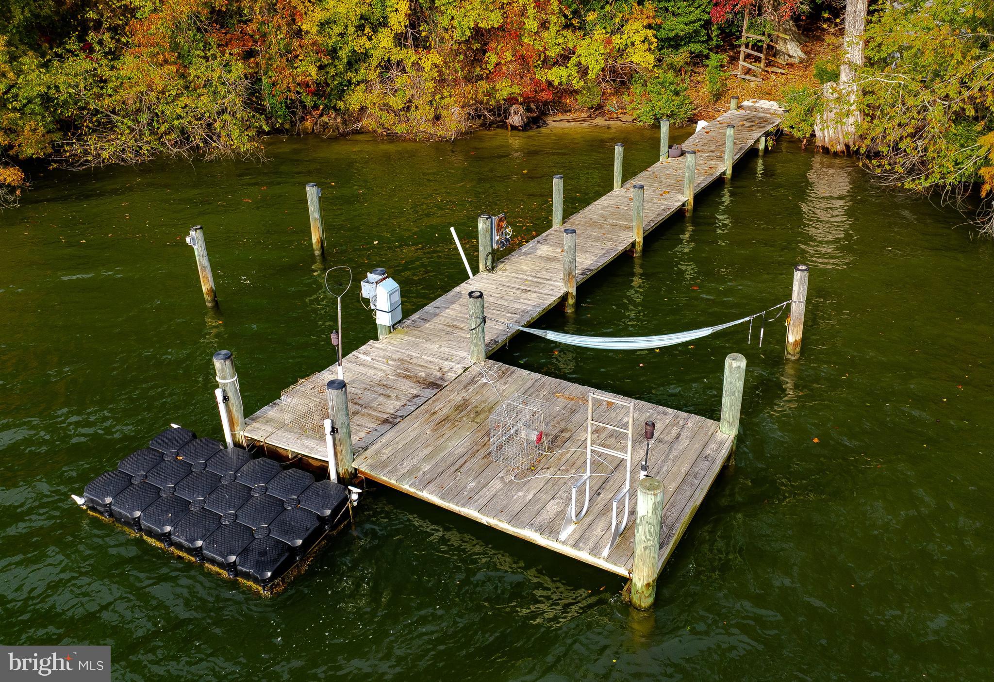 43979 Drum Cliff Road Hollywood, MD 20636 - Photo 48 of 57 a view of a wooden deck and lake